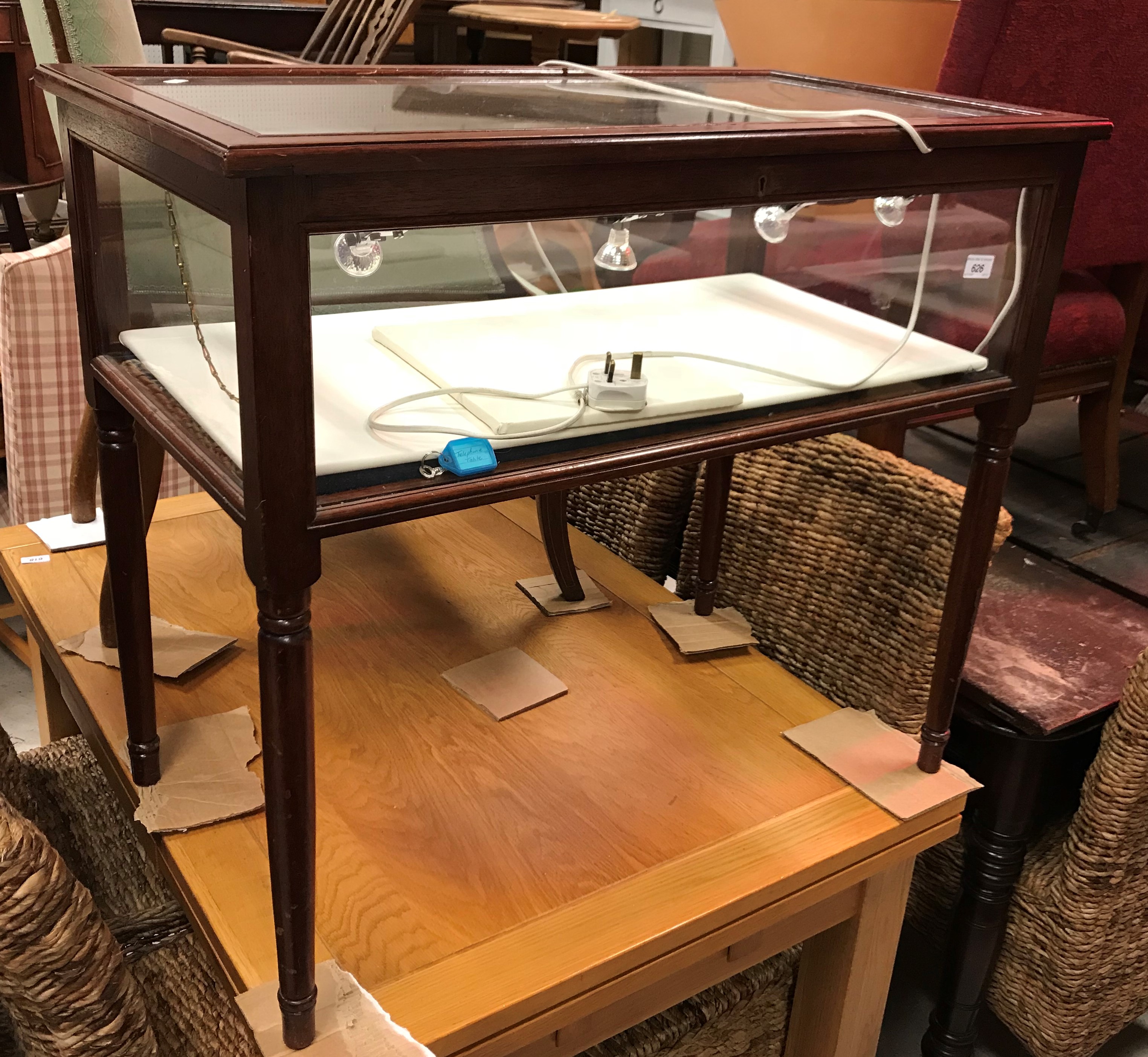 A 20th Century mahogany framed bijouterie table with rising top over the glazed sides,