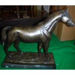 A 20th Century patinated bronze figure of a stallion on a black marble rectangular base 44 cm long