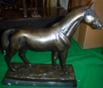 A 20th Century patinated bronze figure of a stallion on a black marble rectangular base 44 cm long