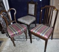 A collection of four Edwardian mahogany dining chairs with drop-in seats,