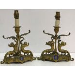 A pair of 19th Century gilt brass table candlesticks as putti with scrolling acanthus bases,