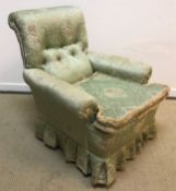 A late Victorian buttoned upholstered scroll armchair on turned and ringed front legs to later