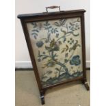A circa 1900 rosewood framed fire screen with silk needlework panel of stag and blossoming tree, 55.