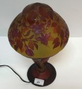 A 20th Century cameo glass lamp in the manner of Gallé with all over floral decoration in red on a