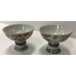 A pair of 19th Century Chinese famille rose stem cups,