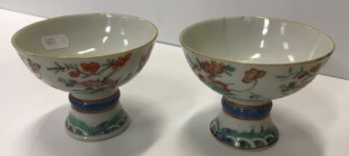 A pair of 19th Century Chinese famille rose stem cups,