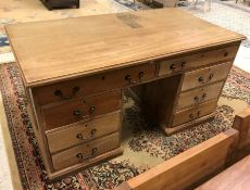 A pine double pedestal desk with mahogany top over two drawers on two banks of three drawers with