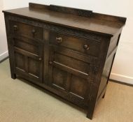 An early 20th Century oak sideboard with lunette style decoration,