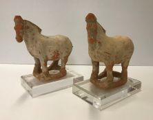 A pair of Chinese terracotta figures of horses in the Han Dynasty style,