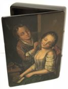 A 19th Century lacquered papier-mache snuff box depicting “Young man tickling a sleeping girl,