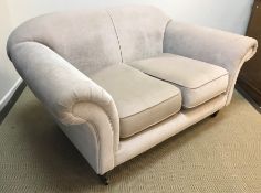 A modern fawn upholstered two seat sofa in the Victorian manner with scroll arms on turned legs to