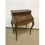 A circa 1900 French rosewood and marquetry inlaid bureau de dame with fitted interior and well over