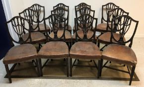 A set of twelve Edwardian mahogany shield back dining chairs in the Hepplewhite taste with brown