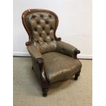 A Victorian mahogany framed button back leather upholstered salon armchair on turned front legs,