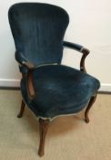 A 19th Century French parlour elbow chair with shaped back and cabriole arms and legs,