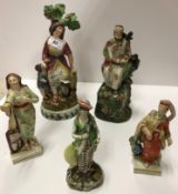 A collection of five early 19th Century Staffordshire pearl ware figures,