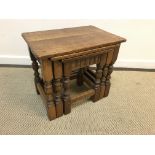 An oak nest of three occasional tables on turned supports to block feet united by stretchers,