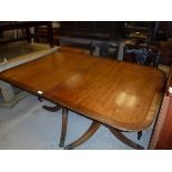 A 20th Century mahogany and cross-banded twin pillar dining table with two leaves, 100.