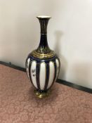 A Royal Worcester blue and gilt decorated stem vase with floral decoration bears blue mark to base