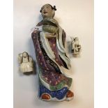 A circa 1900 Chinese polychrome decorated porcelain figure as a "Girl in kimono holding a lidded
