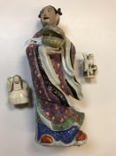 A circa 1900 Chinese polychrome decorated porcelain figure as a "Girl in kimono holding a lidded