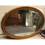 A gilt framed oval wall mirror with bevel edged plate, 97 cm wide x 67 cm high,