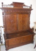 An Italian walnut carved Gothic Revival style hall settle,