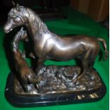 A 20th Century patinated bronze figure group of a mare and foal on a black marble rectangular base