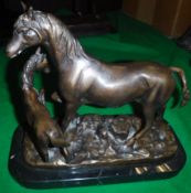 A 20th Century patinated bronze figure group of a mare and foal on a black marble rectangular base