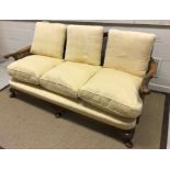 An early to mid 20th Century walnut framed and caned bergère three seat sofa with single caned back