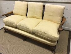 An early to mid 20th Century walnut framed and caned bergère three seat sofa with single caned back