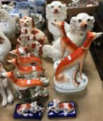 A pair of Staffordshire seated Greyhound figures with rabbit prey,