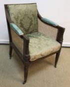 A Regency mahogany framed bergère library armchair with caned back,