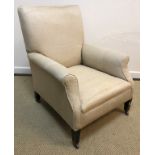 A circa 1900 upholstered scroll armchair on square tapered legs,