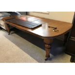 A Victorian oak shallow D end extending dining table with three extra leaves and moulded edge,