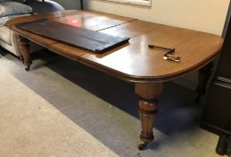 A Victorian oak shallow D end extending dining table with three extra leaves and moulded edge,