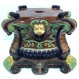 A Victorian majolica jardinier stand of shaped square form with lion mask ring scrollwork and