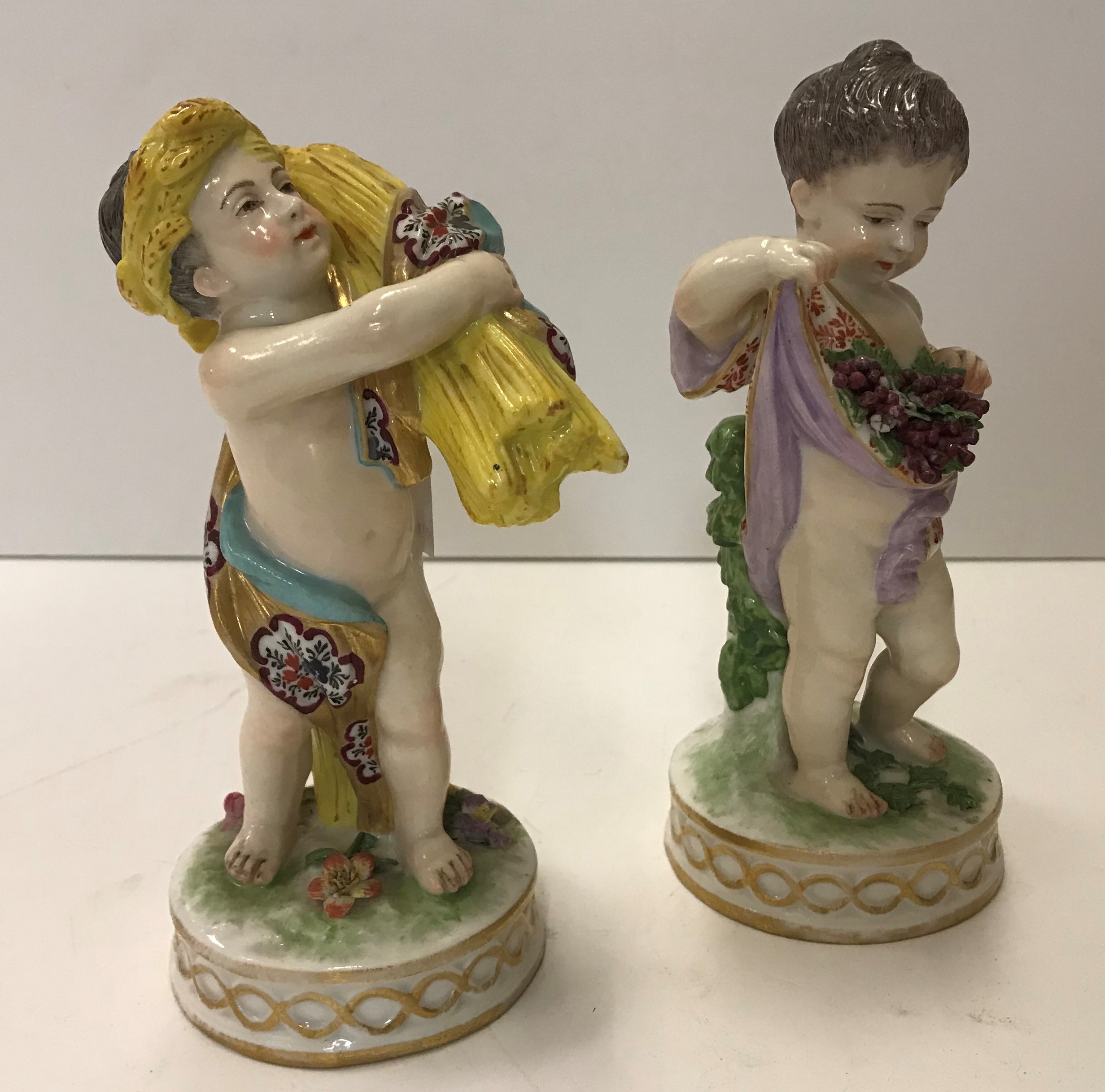 A pair of 19th Century Continental figures emblematic of The Seasons, one with wheatsheaf,