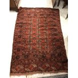 A Bokhara rug with all-over elephant foot medallions and stylised tarantula medallion decoration on