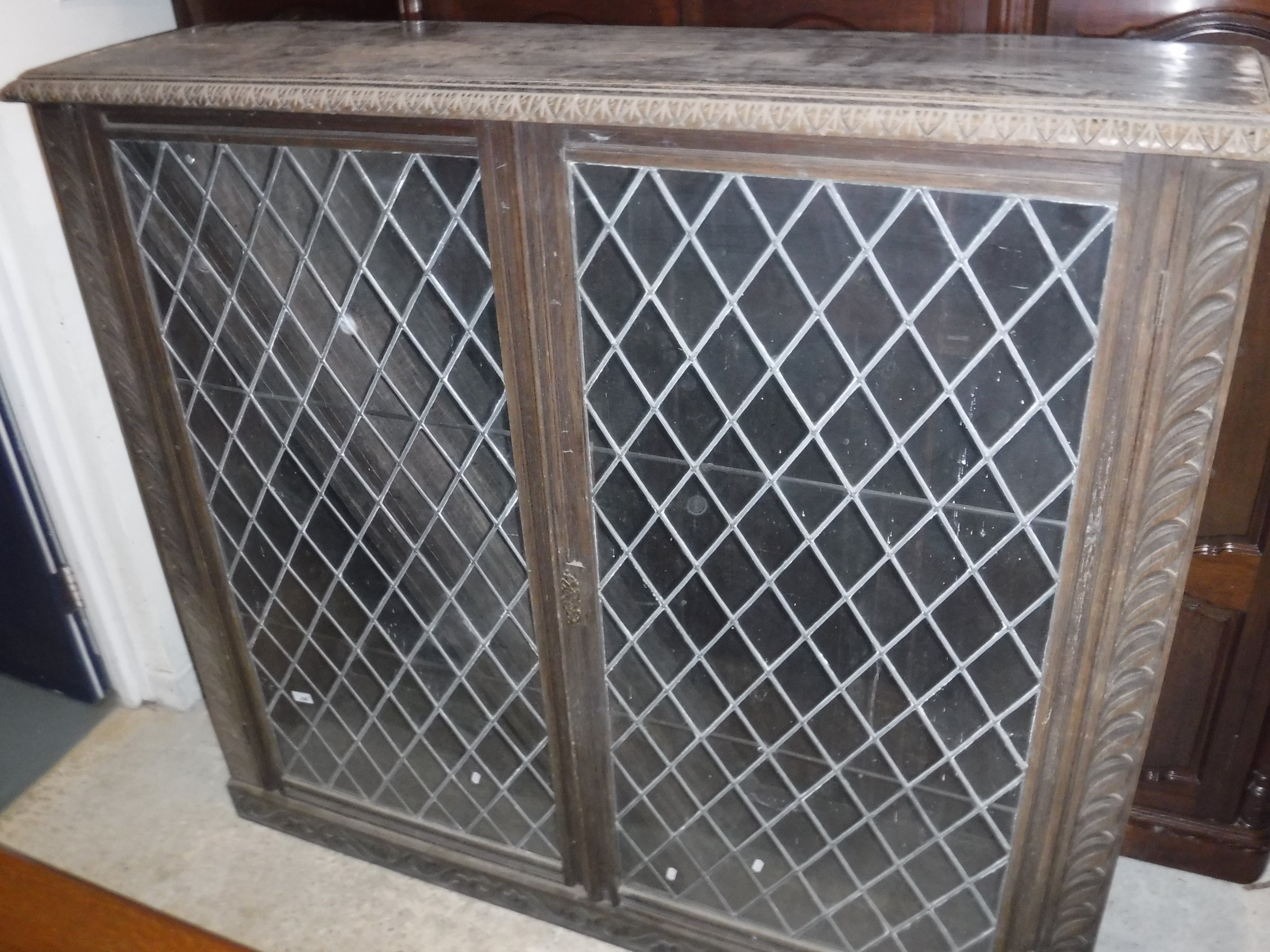 A carved oak display cabinet in the 17th Century style,