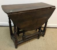 An 18th Century and later oak oval gate-leg drop-leaf dining table on turned supports to block feet