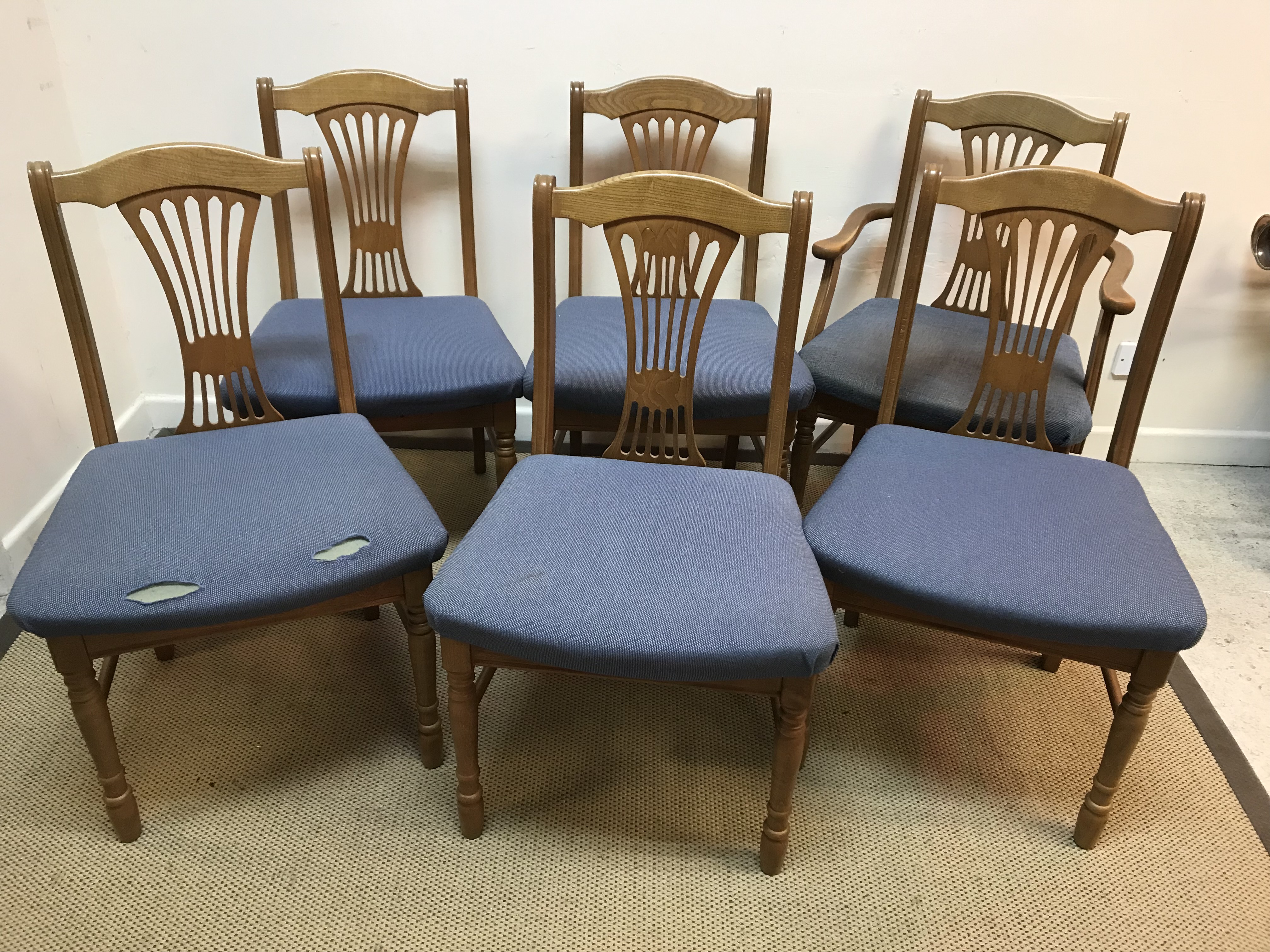 A modern set of six oak framed dining chairs with upholstered seats (5 plus 1)