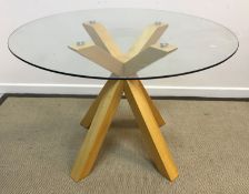 A modern circular breakfast table with glass top on a stained beech quadruped base, 109.