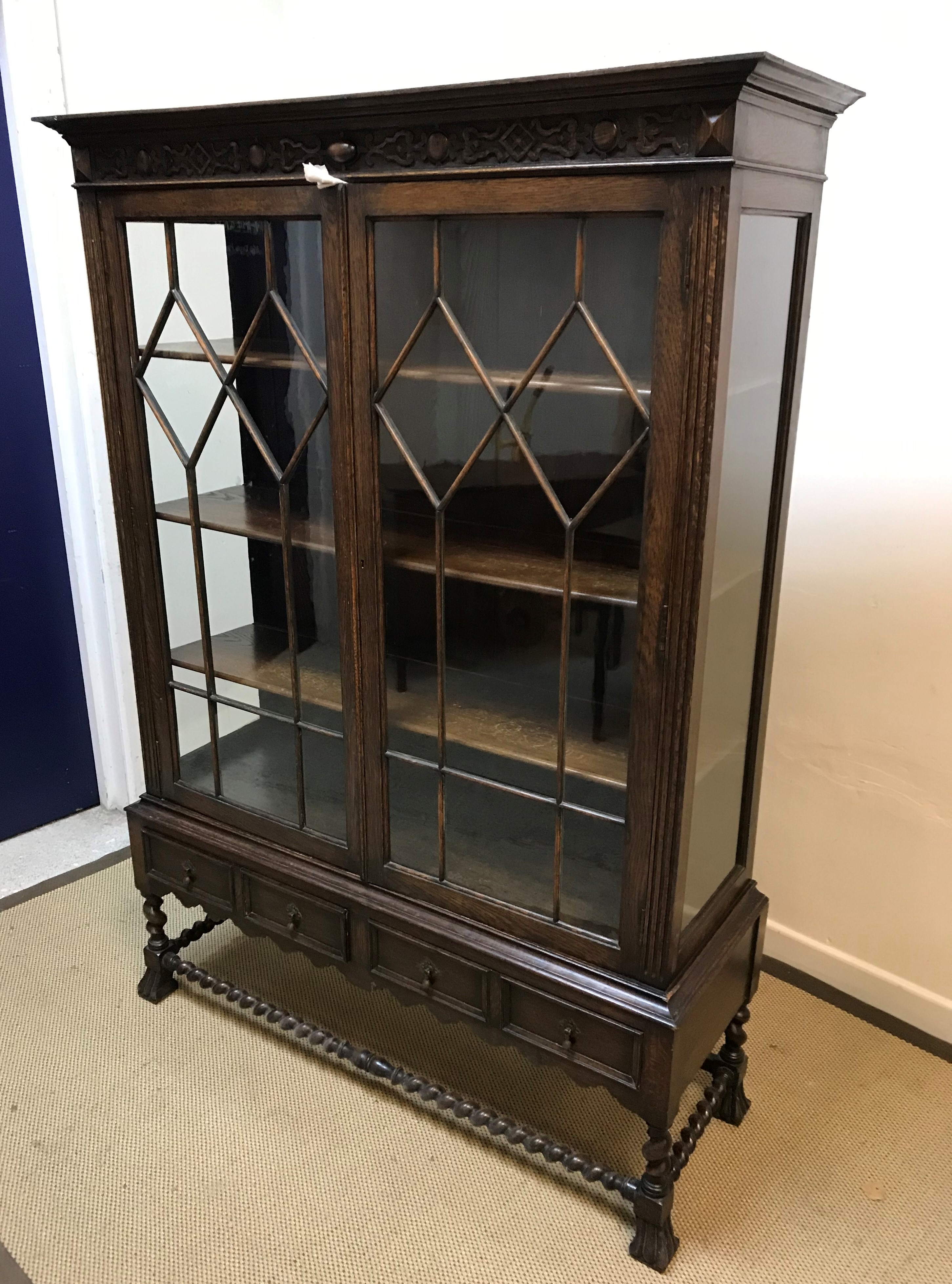 An early to mid 20th Century oak display cabinet,