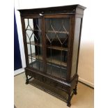 An early to mid 20th Century oak display cabinet,