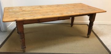 A circa 1900 pine farmhouse style kitchen table on turned and ringed legs,