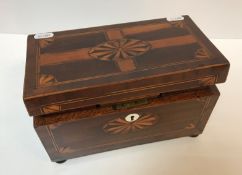 An early 19th Century mahogany and inlaid tea caddy with fan marquetry medallion decoration,