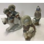 A collection of three Lladro Eskimo figure groups including "Two children upon the back of a Polar