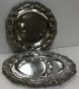 A pair of Edwardian silver salvers with shell and acanthus decoration to edge (by James Dixon & Son,