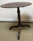 A late George III oak tea table, the oval snap top on a turned and ringed pedestal to tripod base,